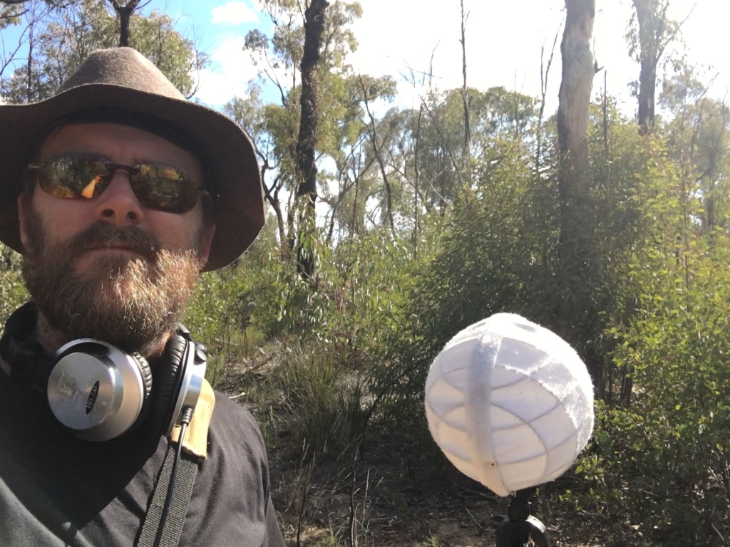Sound recordist in the Australian bush with field recording gear